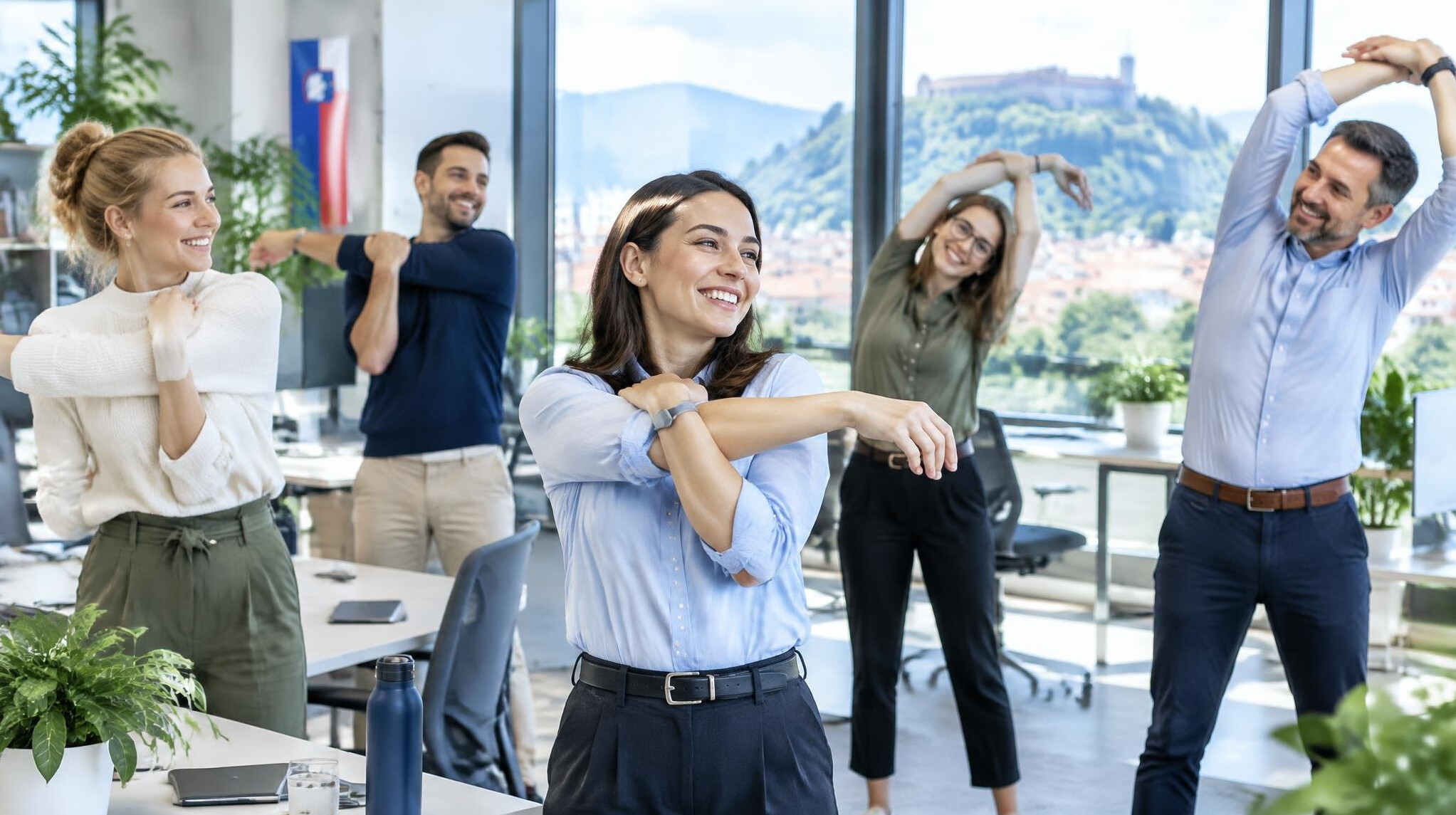 Office employees stretching together during a workplace wellness session